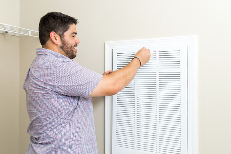 Man replacing air filter.