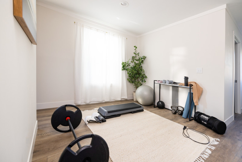 Flex space of a Clayton manufactured home with white walls and rug, a window and gym equipment