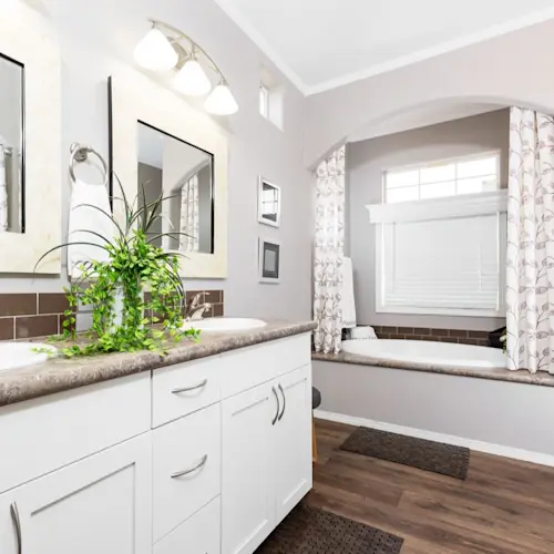 The lovely oval tub in Enchantment 3070A is the perfect place to retreat to, along with dual mirrors and sinks, and plenty of storage space.