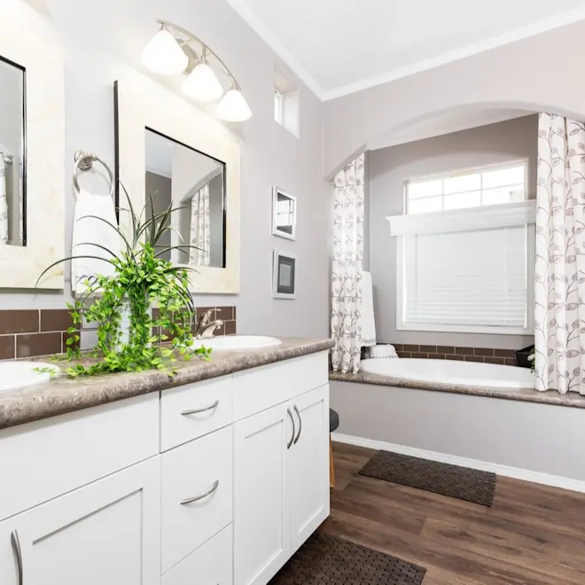 The lovely oval tub in Enchantment 3070A is the perfect place to retreat to, along with dual mirrors and sinks, and plenty of storage space.