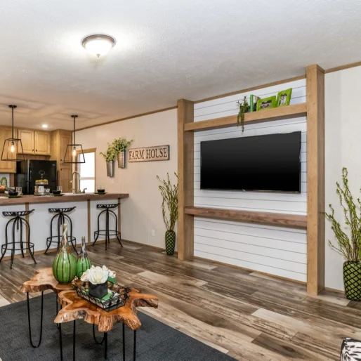 The living room in [model name] features a shiplap media wall and weather-style flooring.
