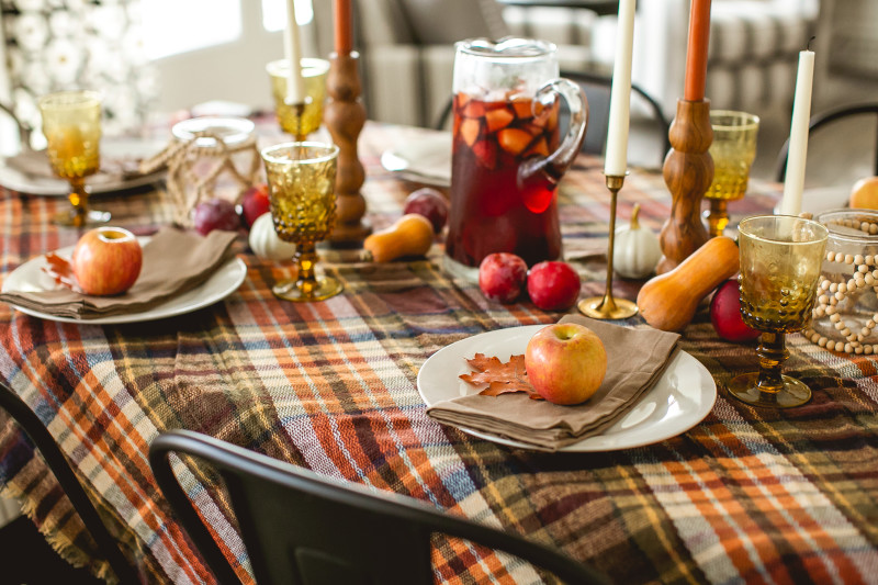 Thanksgiving table with red and orange décor.