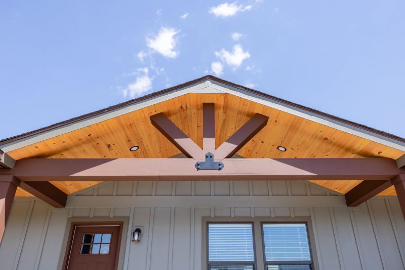 Roof of a Clayton CrossMod home with wood and brown details, and beige siding below it.