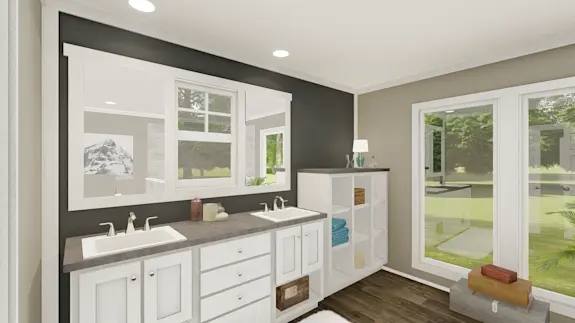 The [model name] features a primary bathroom with two tall windows for natural light and built-in storage.