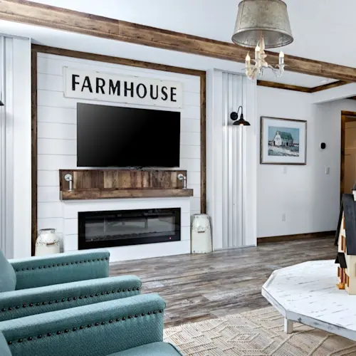 The living room in The Liza Jane features ceiling beams and an electric fireplace.