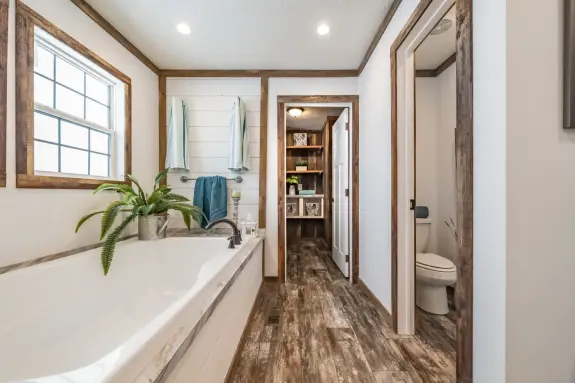 Have all the space you need with this spacious walk-in closet off the beautiful primary bathroom of The Emma Jean. Take advantage of the built-in shelves and cubbies perfect for storage room for delicate sweaters, purses, shoes and more!