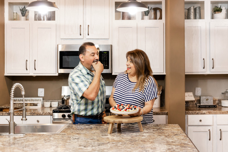 Couple shares dessert in their kitchen