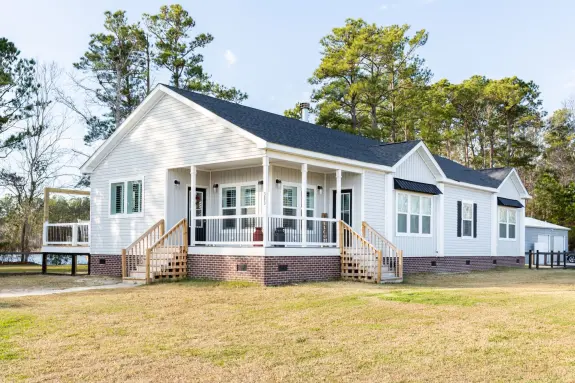 The front porch on the 1434 Carolina "Southern Belle" exterior has two sets of stairs and two door entrances for a stylish and functional entryway to this home.