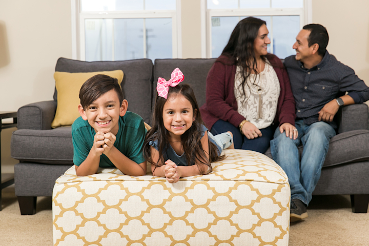 Family gathered in the living room of a manufactured home making memories together.