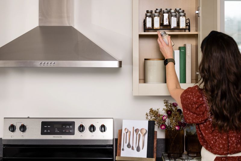 woman looking in organized cabinet