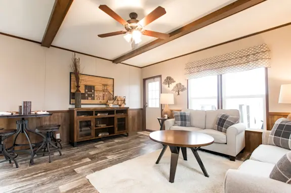  The Lodge living room features ceiling beams and wood style details throughout.