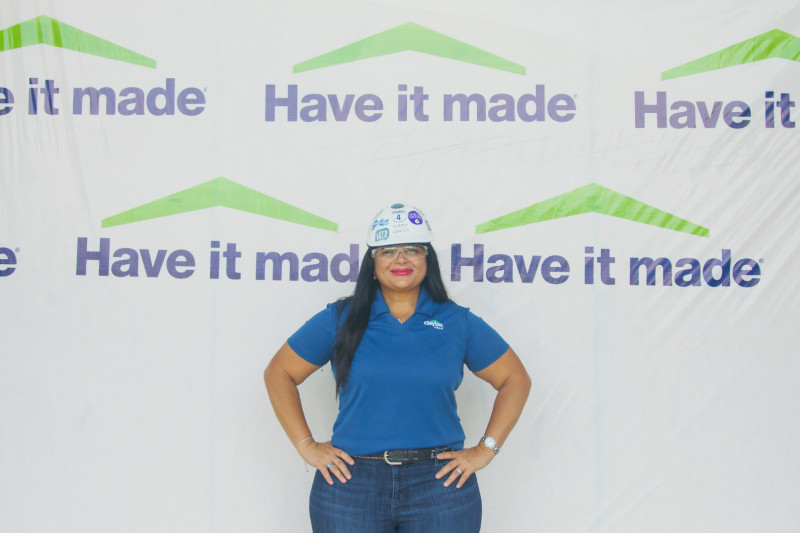 Sandy Santos, Clayton TMX manager, standing in front of a completed Clayton Built® home.