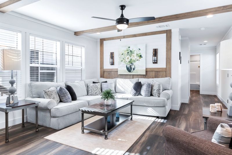 Manufactured home living room with white décor and wooden accents.