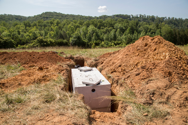 A septic tank being buried during on-site completion of construction for a manufactured home.