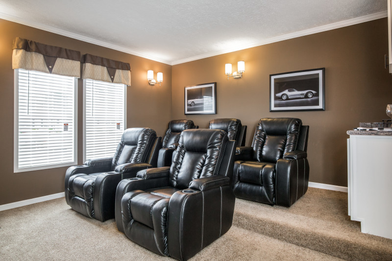Theater room of the Lloyd with four large black leather recliners.