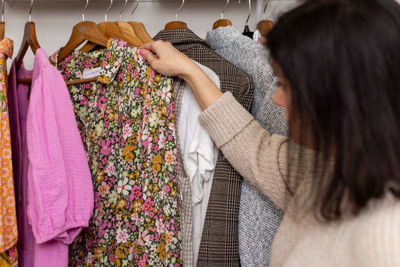 Woman looking at clothes in closet