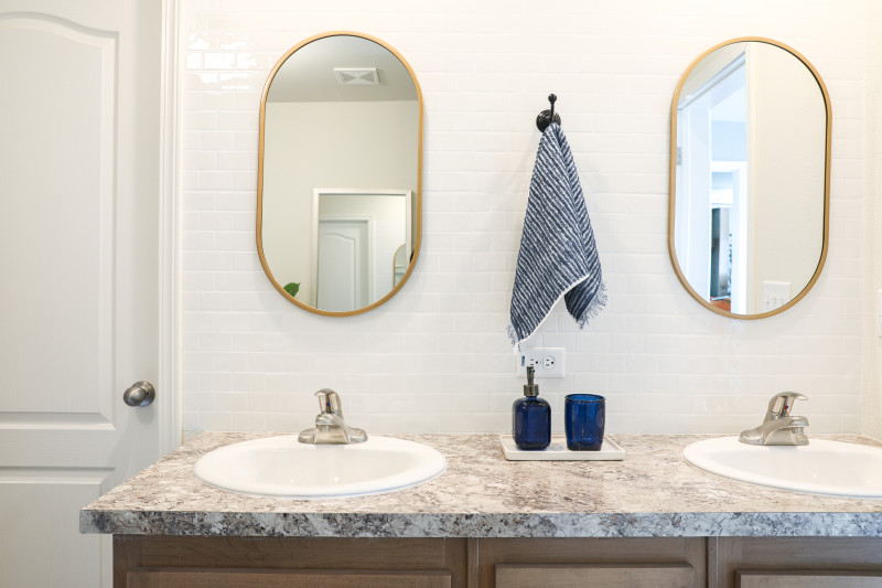 modern master bathroom with gold and navy accents