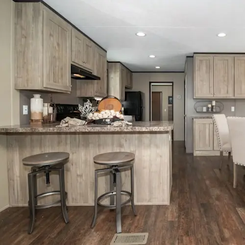 This beautiful kitchen from the Anniversary 16682A has a modern, elegant look that will make any guest feel welcome. With neutral colors, plenty of storage and laminate wood flooring, a kitchen like this will make any house feel like home.