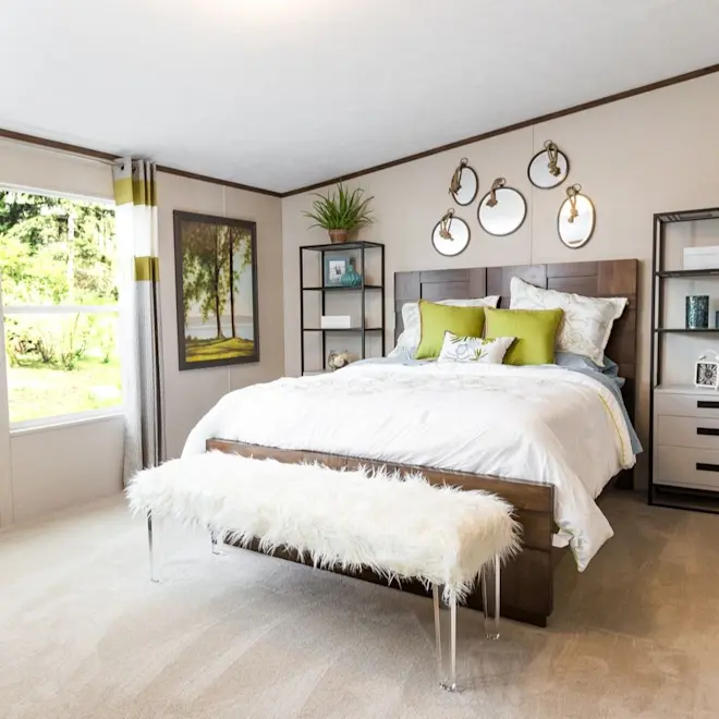 Light green colors and fluffy accents add a comfortable, chic feel to the bedroom in the Thrill.