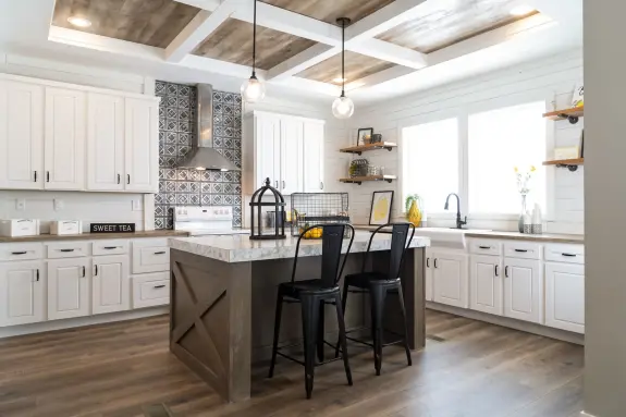 The kitchen of [model name] features a coffered ceiling and shiplap walls.