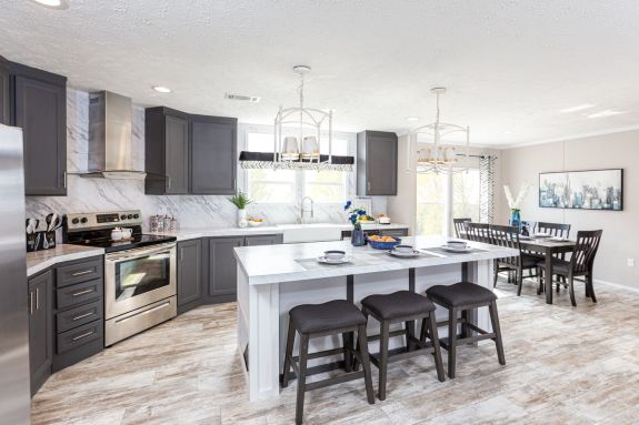 Step into your dream kitchen with beautiful marble-style backsplash and counters, cool grey cabinets and bright whites that extend throughout this open floor plan kitchen and dining rooms in the Stella home.