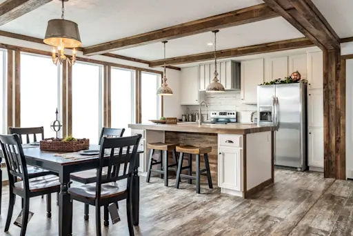 The back wall of the kitchen and dining room in The Avalyn is lined with five large floor-to-ceiling windows making this already open floor plan seem like it goes on for miles!