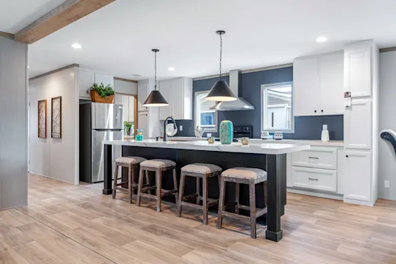 The Anatolia features a sleek kitchen with a long kitchen island and stainless steel appliances.
