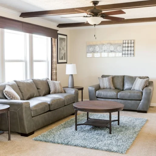 This gorgeous living room from our [model name] home has a great color combination and exposed wooden beams.