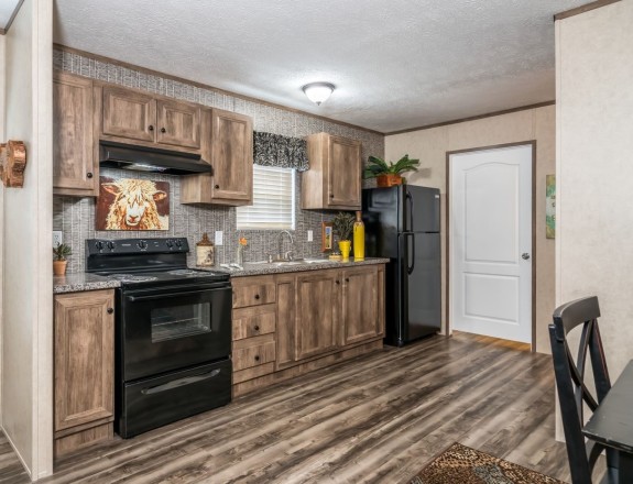 The Blazer 56 B is a great smaller home with an open kitchen that has a stylish backsplash and natural finished cabinetry. Plus you have the options for a built-in entertainment center, fireplace and bar area.