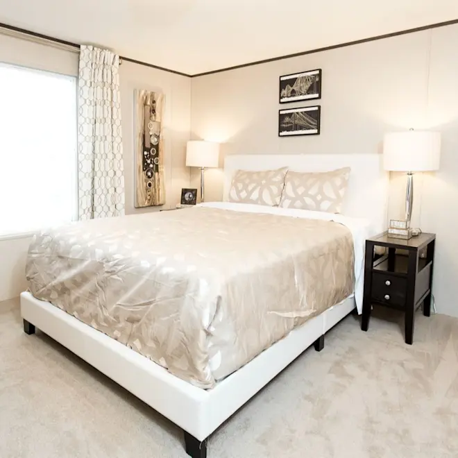 The bedroom in Bliss features a walk-in closet and plush carpet.