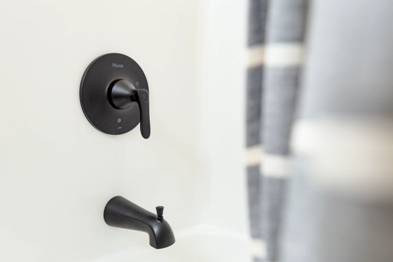 Close-up of a black faucet in the bathtub of a Clayton manufactured home bathroom.