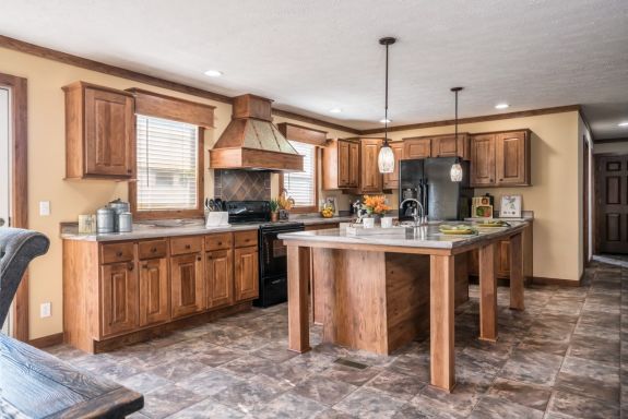 Check out the kitchen island and decorate range hood in the Cheyenne mobile/manufactured/modular home.