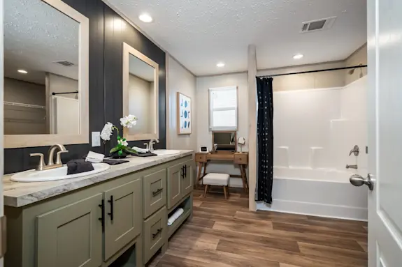 The [model name] features dual sinks and an open corner nook to put a makeup vanity or laundry hampers there.