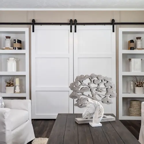 These sleek barn sliding doors are a classy cover for the entertainment area in the The Reserve 60 living room.