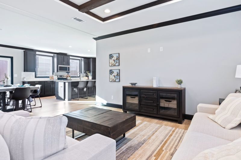 View of the front living room looking toward the kitchen and dining room of the Clayton Homes home model, The Louis.