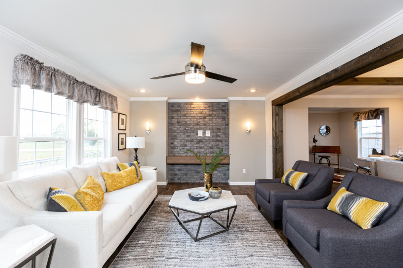 A manufactured home living room with a brick entertainment center and wood styled flooring.