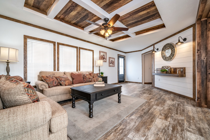 The living room of the Avalyn with white walls and neutral furniture.