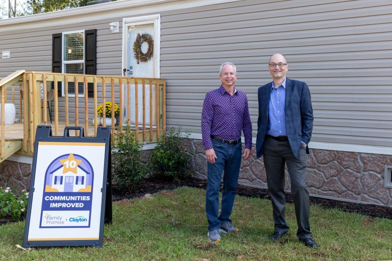 Kevin Clayton, Clayton CEO, and Claas Ehlers, Family Promise CEO, stand in front of the tenth off-site Clayton Built home the company donated to the nonprofit.