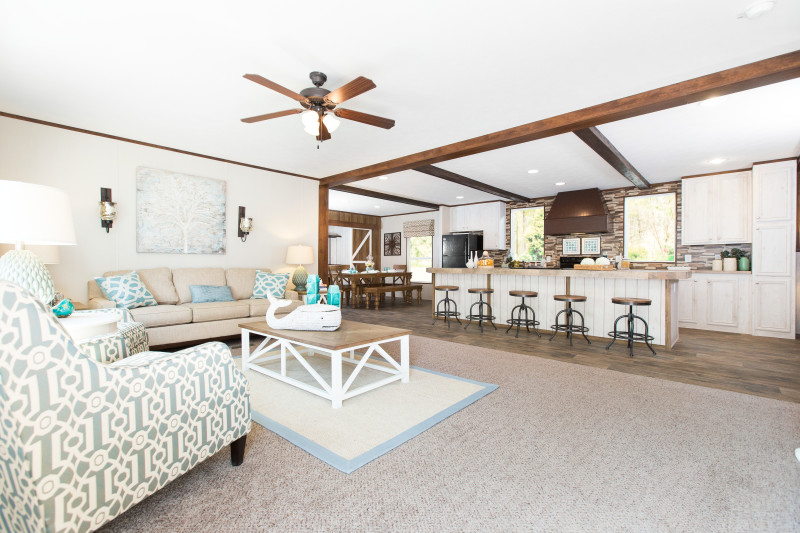 Spacious living room and large kitchen with wooden beams running across the ceiling.