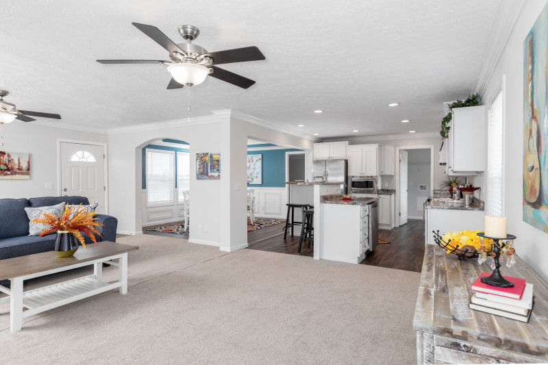 Shaw carpets in the living area of a manufactured home with view into kitchen area.