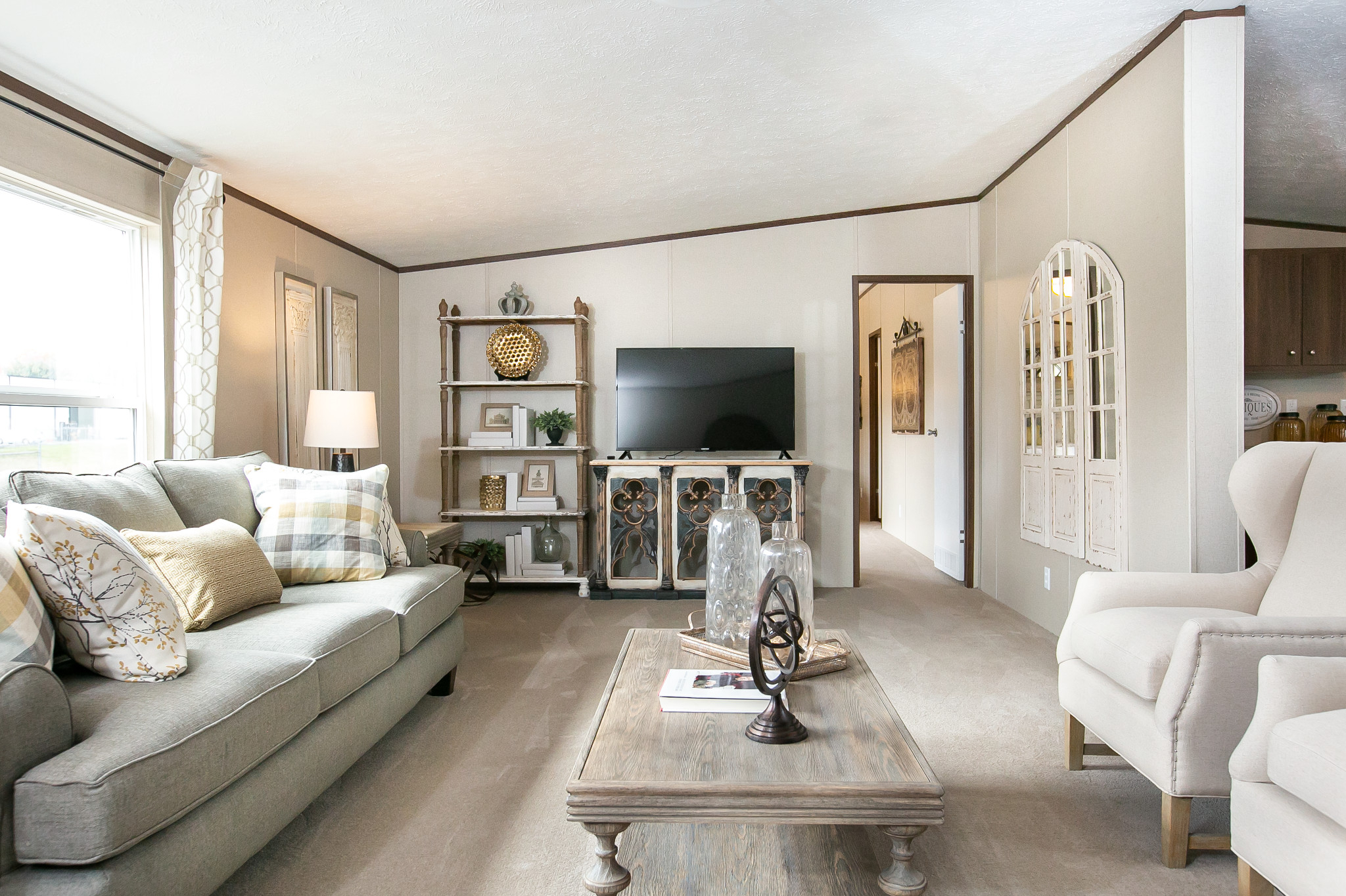 Neutral colored living room with cream colored furniture and accents. 