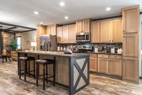 The Boujee 2 is luxury meets cabin and features a large kitchen island and wood-style details.