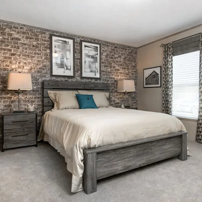 Take a look at this relaxing retreat bedroom from The Real Deal which offers a soothing vibe with plush carpeting, plenty of space and a show-stopping brick decorative wall!