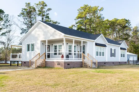 The [model name] features a side porch and double dormers.