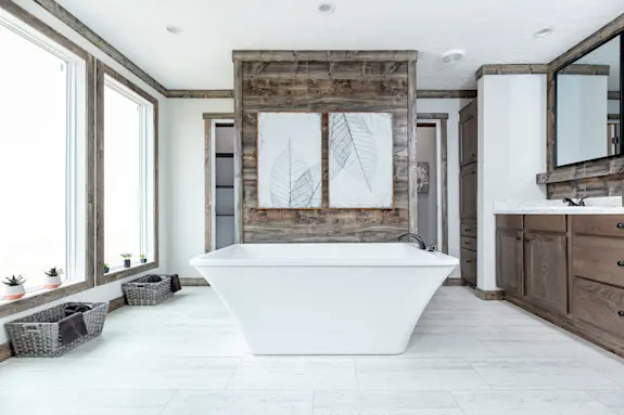 The primary bathroom of [model name] features a spa soaker tub and a hidden walk-in shower.