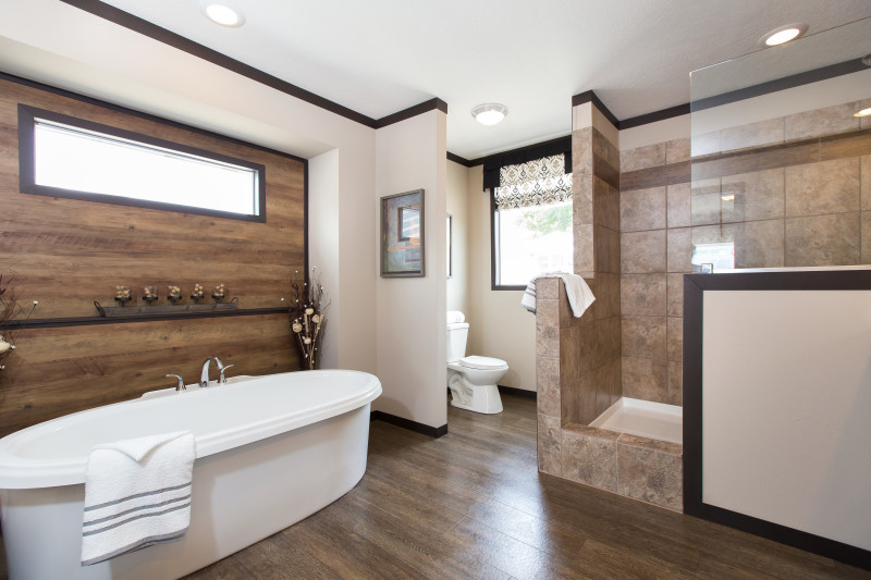 A manufactured home master bathroom with a large soaker tub and walk-in shower.