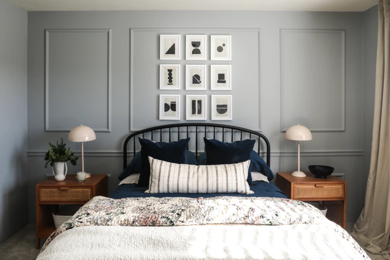 Primary bedroom with gray walls, cherry rail walls and modern cozy accents