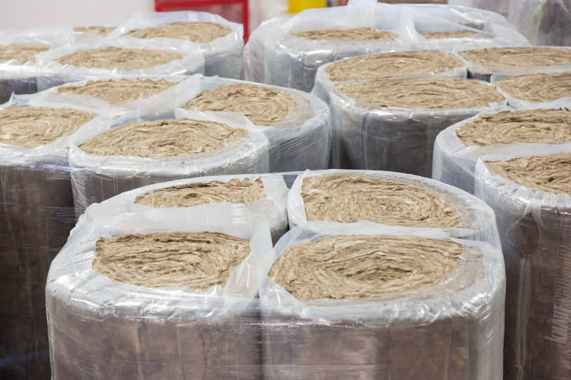 Insulation ready to be used in a manufactured home inside of a home building facility.