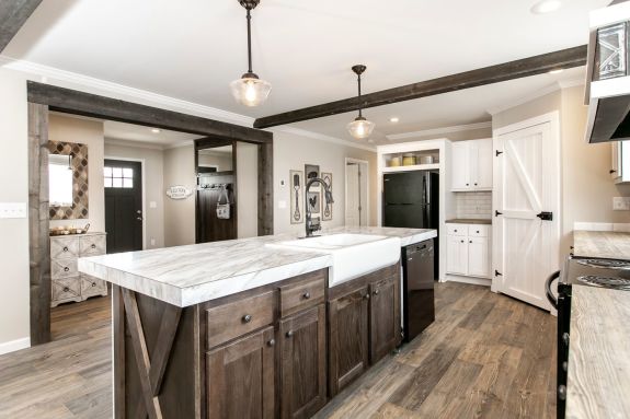 The [model name] features 9 foot ceilings, a beautiful primary suite and this farmhouse kitchen with ceiling beams, subway-tile backsplash and a walk-in pantry.