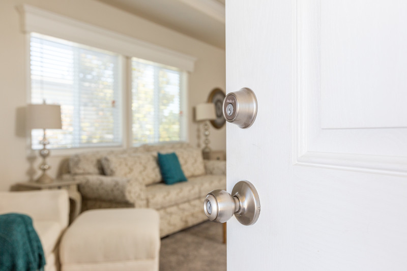 View of a manufactured home living room from an open front door with Kwikset door hardware